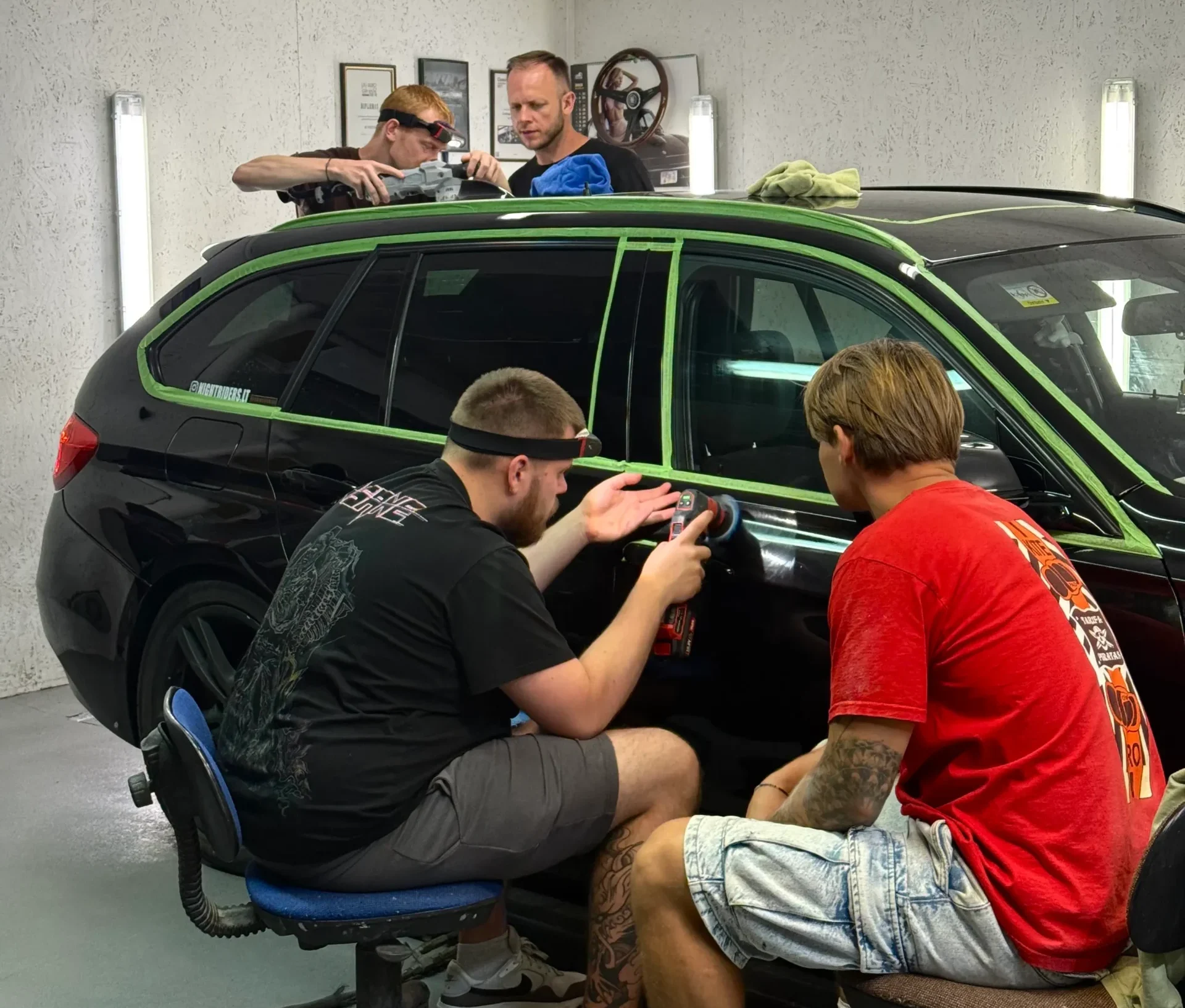 People polishing car with detailing products