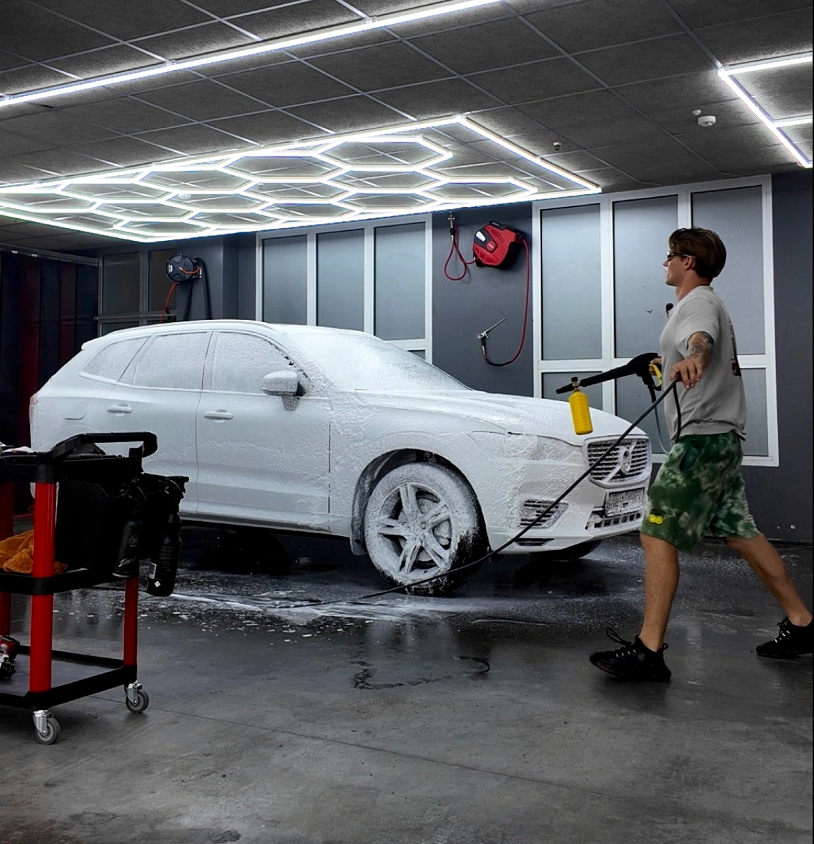 Car being washed with foam spray.