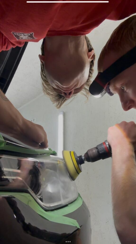 Headlight polishing in progress with polishing pad and compound
