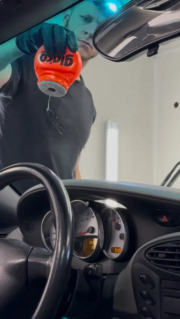 Detailer working with car glass ceramic coating